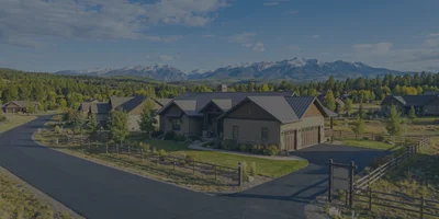 A beautiful, harmonious mountain neighborhood in Pagosa Springs showcasing wildlife-friendly split-rail fencing and well-maintained properties.